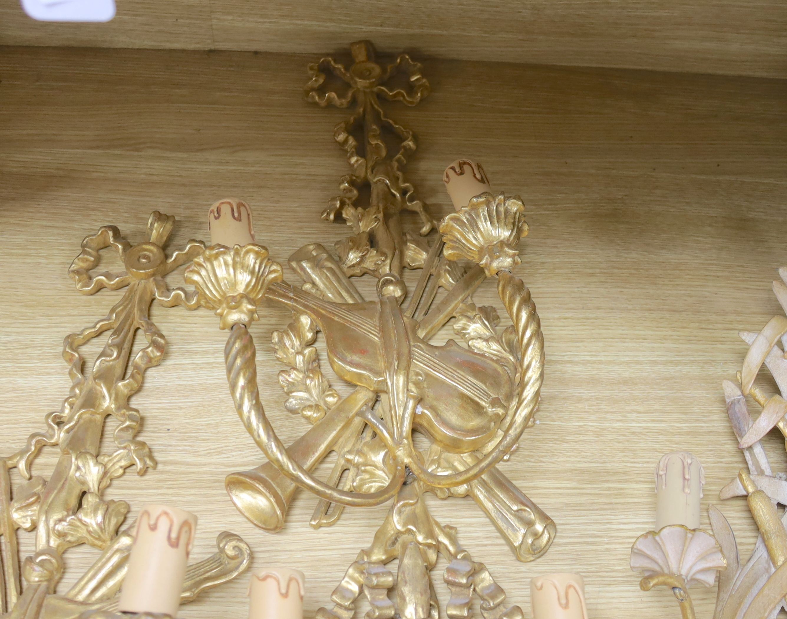 Two pairs of 18th century style Italian giltwood two branch wall lights and one other wall light, 62 cms high.